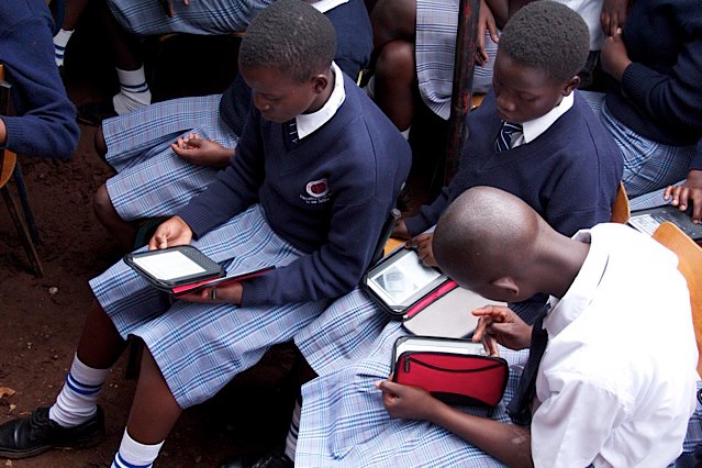 Students using e-readers at the Kibera Girls Soccer Academy © World Reader