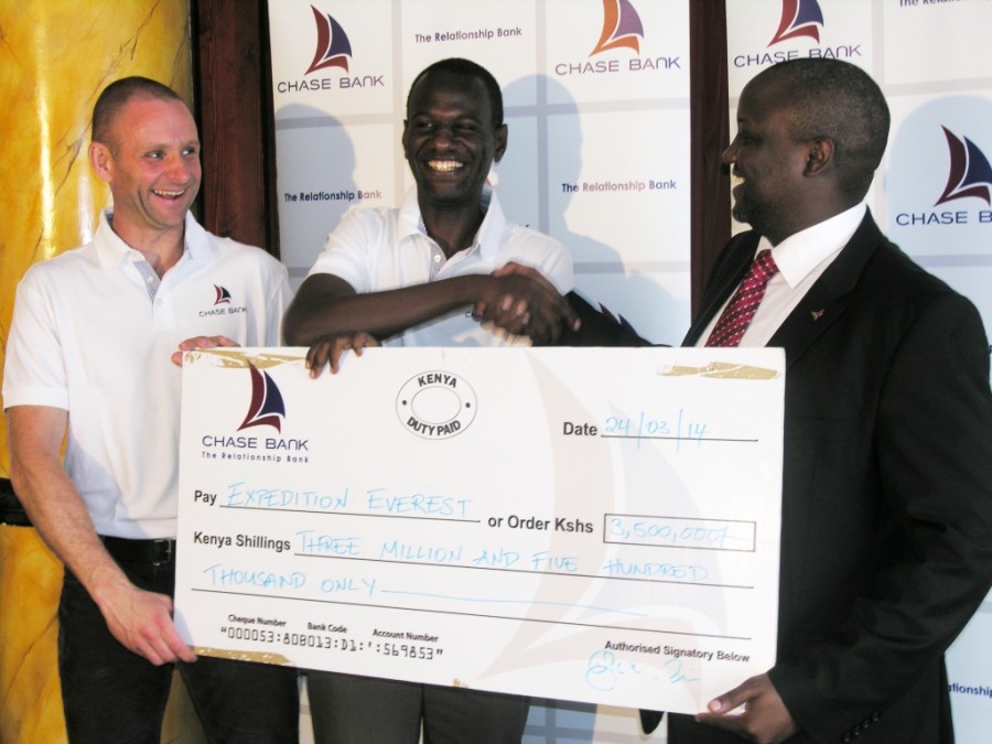 Chase Bank Assistant General Manager for Business Development Vincent Lubia (right) presents a cheque of Ksh 3.5million to Kenyaâ€™s first  Mount Everest climber Steve Obbayi (centre), Kenya Everest Expedition founder Toby Storie â€“Pugh (right)