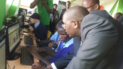 Safaricomâ€™s Director of Corporate Affairs Nzioka Waita takes Neslon, a student at Thika School for the Blind through the new Safaricom website
