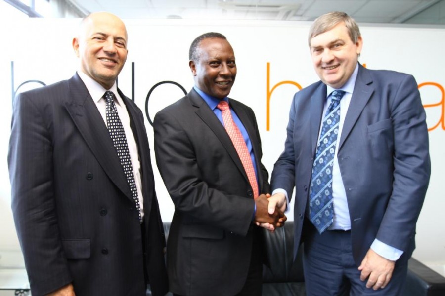 Board Chair of Orange Telkom Kenya, Eddy Njoroge (centre) congratulates Vincent Lobry (right), the new CEO