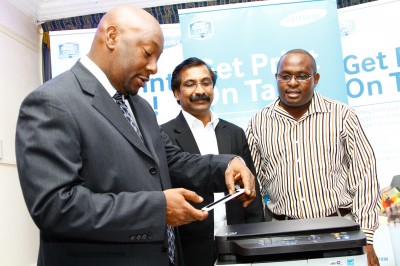 Robert Ngeru (left), Samsung Vice President and COO for East and Central Africa, Nandan Nair, Samsung's Business Lead for Printers and Tablets Division (centre) and Albert Kigada, the Regional Manager, Printing Solutions.