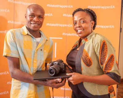 Microsoft Mobile East Africa Communications Manager Lilian Nganda (right) presents a camera and laptop to Lumia Make it happen competation winner Allan Ojango